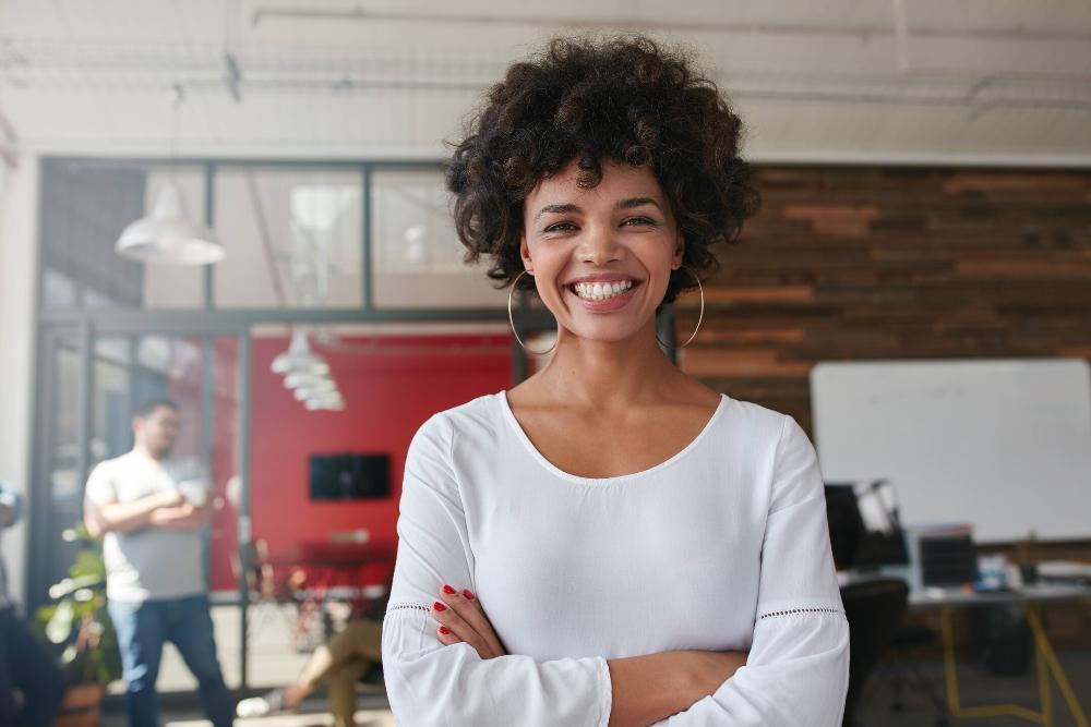woman smiling with bright smile while standing in office