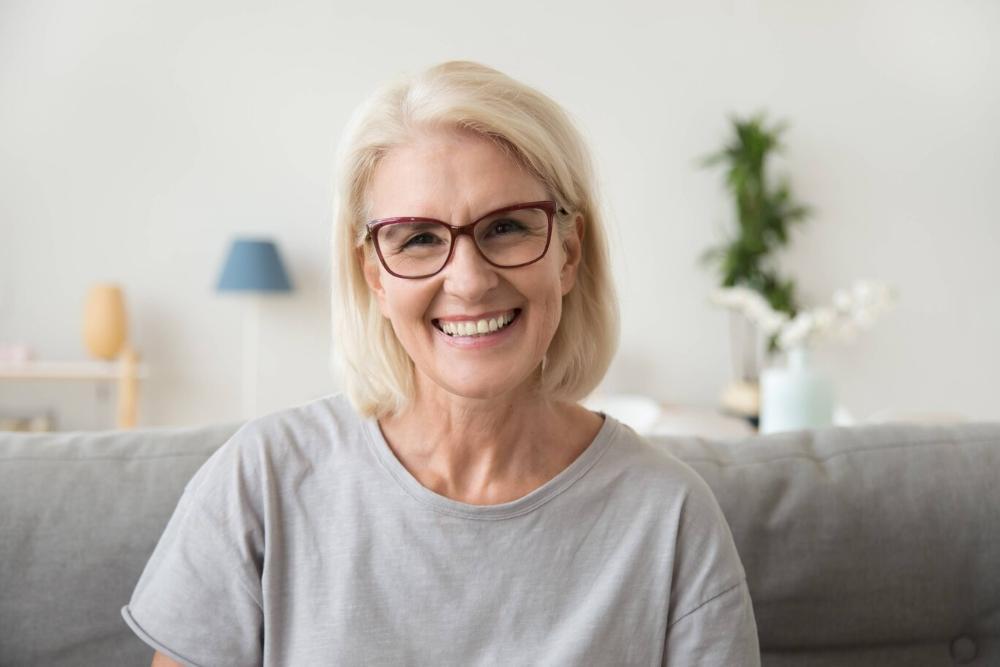 woman smiling after getting dental implants