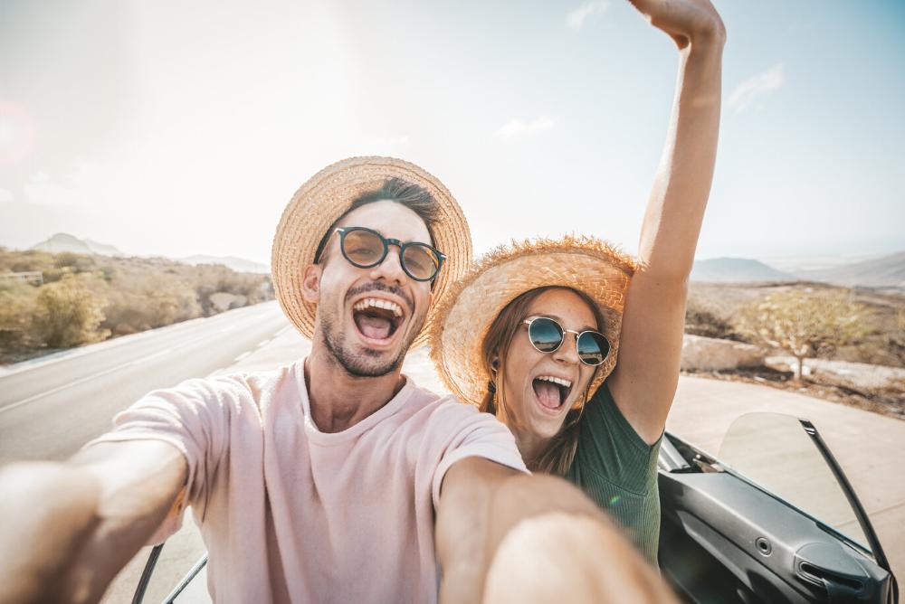 man and woman smiling and taking a selfie