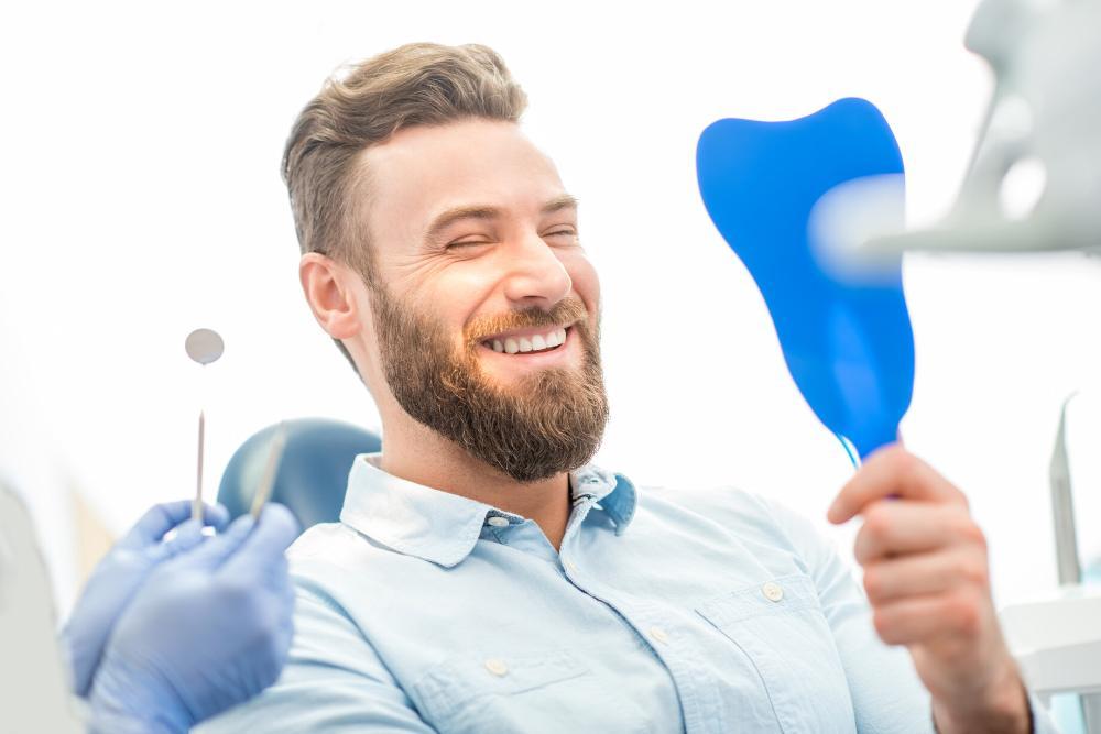 man looking at clean smile after dental exam
