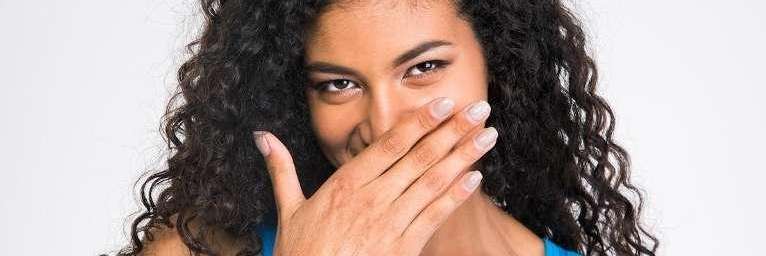 Lady smiling after getting Invisalign clear aligners from Randolph Dental Associates