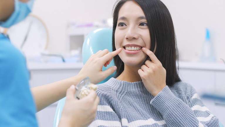 A female patient after a Professional Teeth Cleaning and Exam in Randolph, NJ