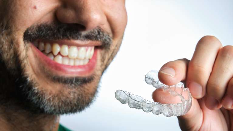 Man holding Invisalign clear aligners in Randolph, NJ