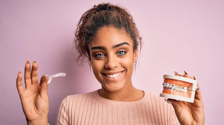 An image of a young woman holding Invisalign in Randolph, NJ