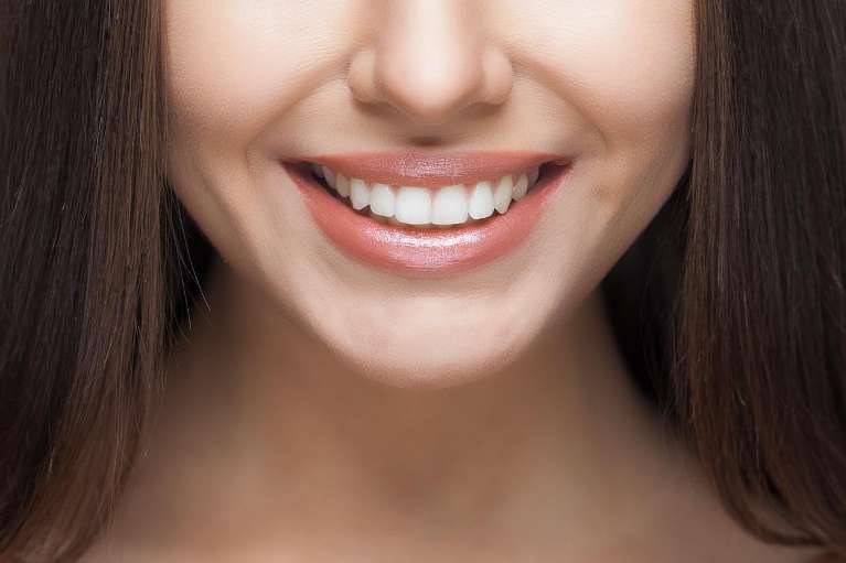 A smiling woman after Invisalign in Randolph, NJ