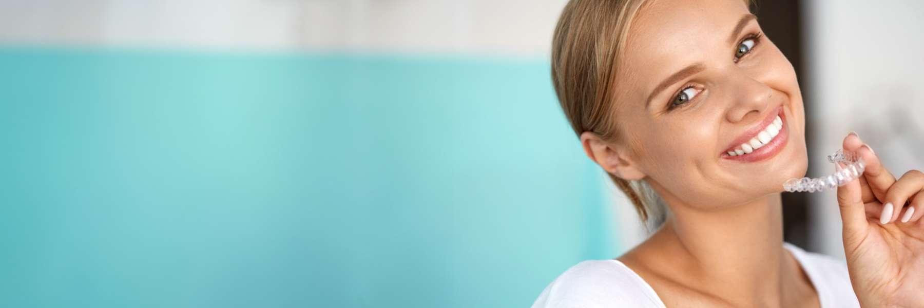 A woman holding a Clear Aligners in Randolph NJ