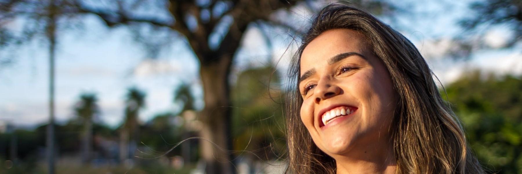 Woman smiling while standing outside