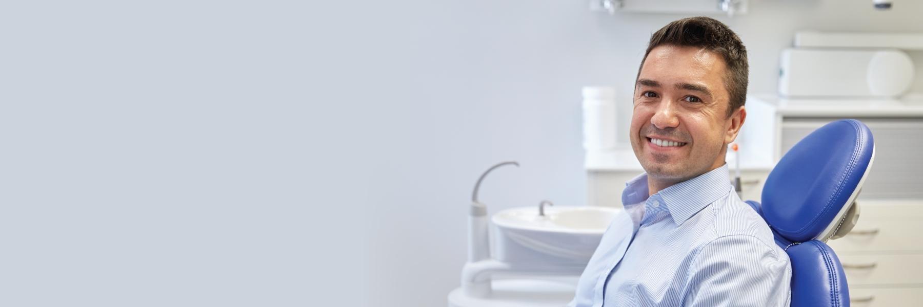 man smiling in dental chair in Randolph dental office